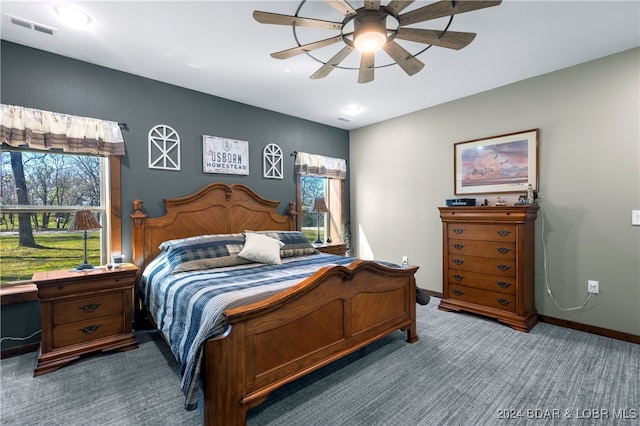 bedroom featuring dark carpet and ceiling fan