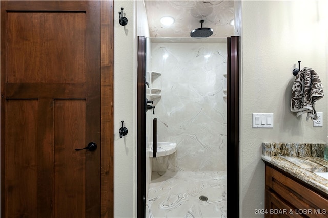 bathroom with a shower and vanity