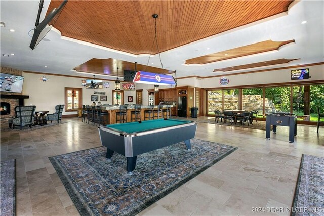 rec room with crown molding, wood ceiling, a fireplace, and pool table