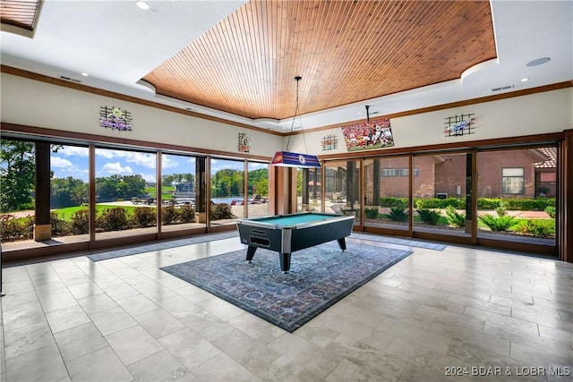 rec room featuring a tray ceiling, wood ceiling, and ornamental molding