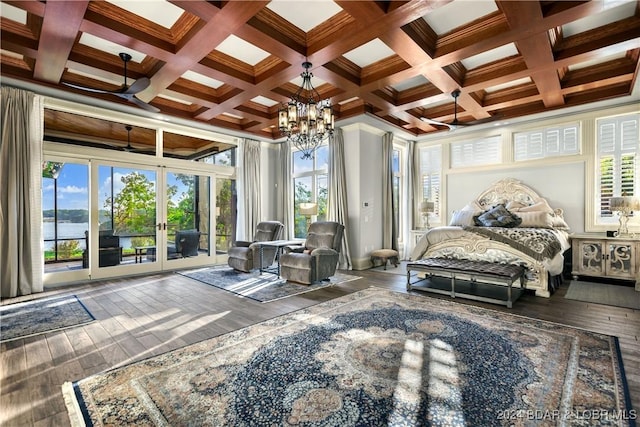 bedroom featuring a water view, access to outside, multiple windows, and dark hardwood / wood-style floors