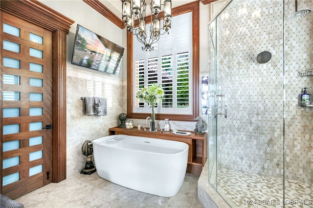 bathroom featuring plus walk in shower, a chandelier, and tile walls