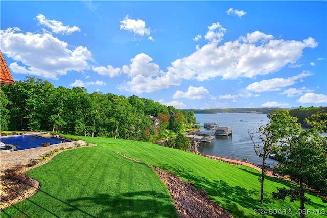 view of yard with a water view and a dock