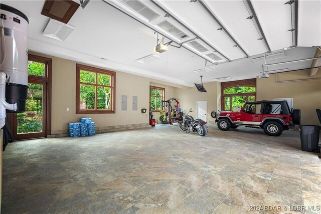 garage with electric panel and a garage door opener