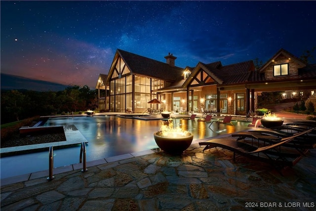 25 Springridge Ln, Villages, MO 65079 - pool at night with a patio area and an infinity pool