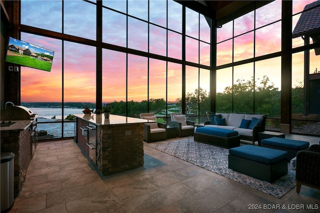 25 Springridge Ln, Villages, MO 65079 - patio terrace at dusk with an outdoor kitchen and an outdoor hangout area