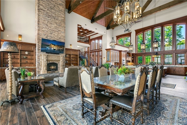 dining room with dark hardwood / wood-style flooring, a fireplace, and high vaulted ceiling