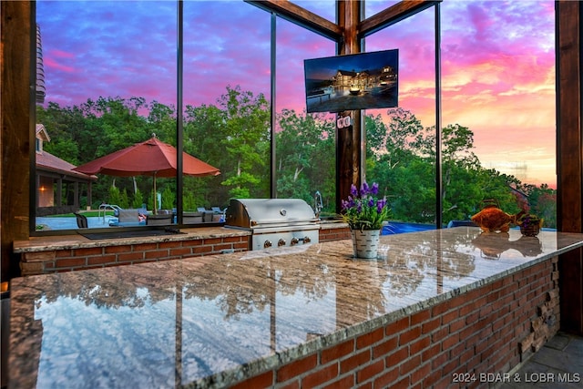 view of patio featuring area for grilling and exterior kitchen