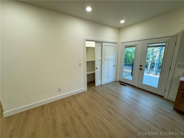 interior space featuring french doors, visible vents, and light wood-style floors