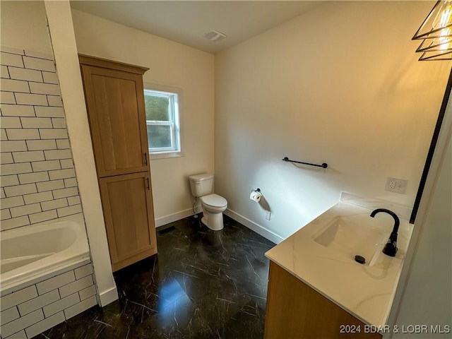 full bath featuring tiled bath, baseboards, toilet, marble finish floor, and vanity