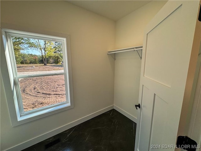 spacious closet featuring marble finish floor and visible vents