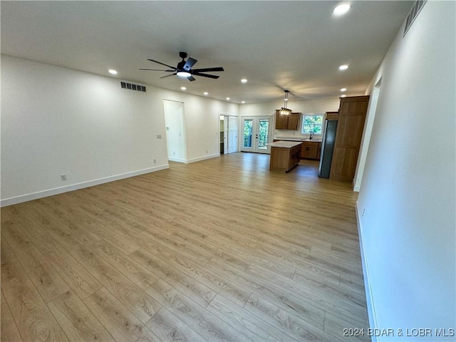 unfurnished living room with baseboards, visible vents, a ceiling fan, light wood-style flooring, and recessed lighting