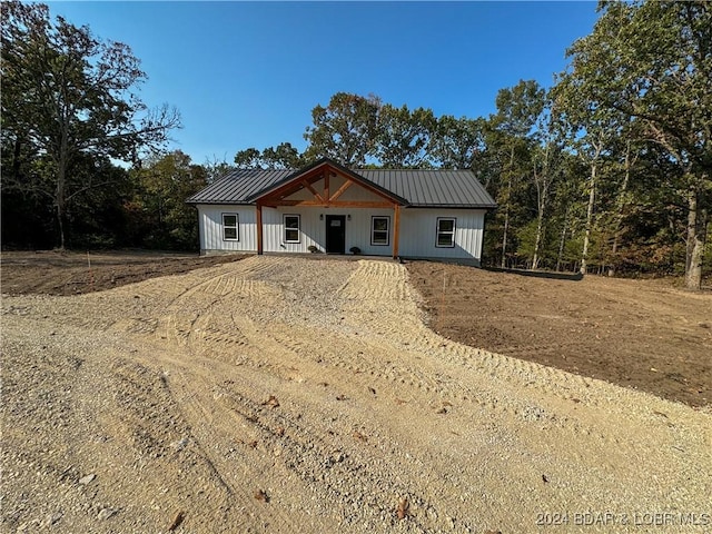 modern inspired farmhouse featuring metal roof and driveway