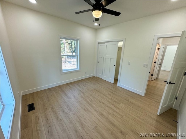 unfurnished bedroom featuring recessed lighting, visible vents, baseboards, a closet, and light wood-type flooring