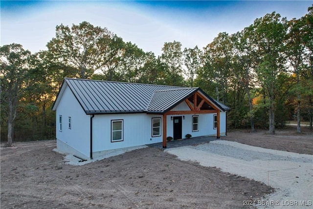 modern farmhouse with a standing seam roof and metal roof