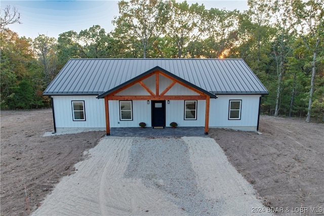 modern farmhouse featuring a standing seam roof and metal roof