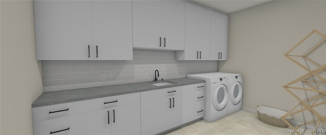 laundry room featuring cabinets, sink, and washing machine and clothes dryer