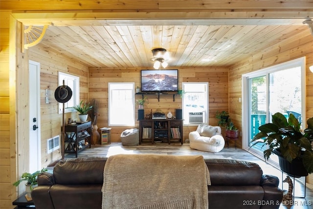 living room with hardwood / wood-style floors and wood walls