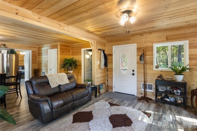 living room with wooden walls, ceiling fan, wooden ceiling, and dark hardwood / wood-style flooring