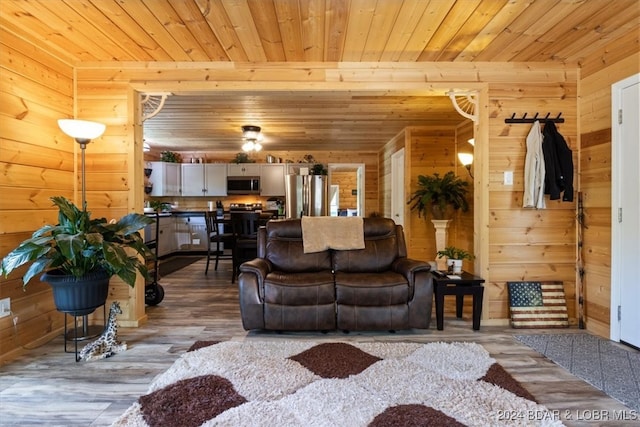 living room with wood walls, hardwood / wood-style floors, and wood ceiling