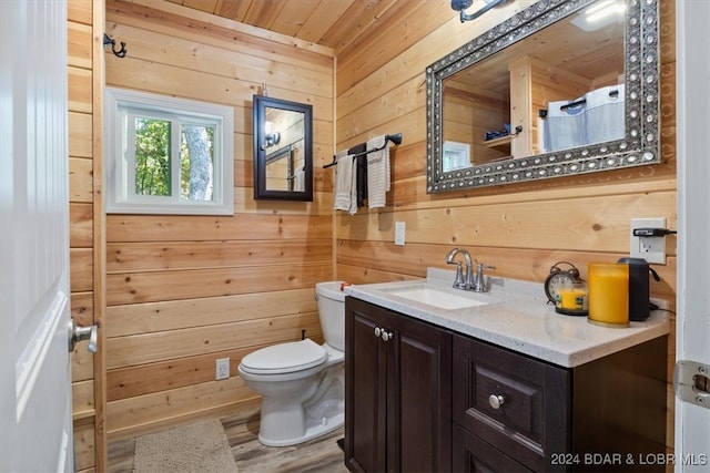 bathroom featuring toilet, wood-type flooring, wooden ceiling, vanity, and wood walls