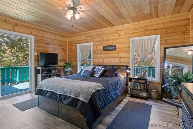 bedroom featuring multiple windows, access to exterior, wood ceiling, and light wood-type flooring