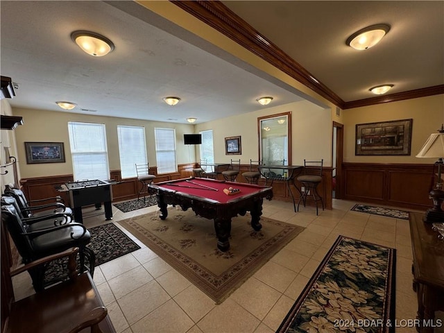 recreation room with wood walls, light tile patterned flooring, ornamental molding, and pool table