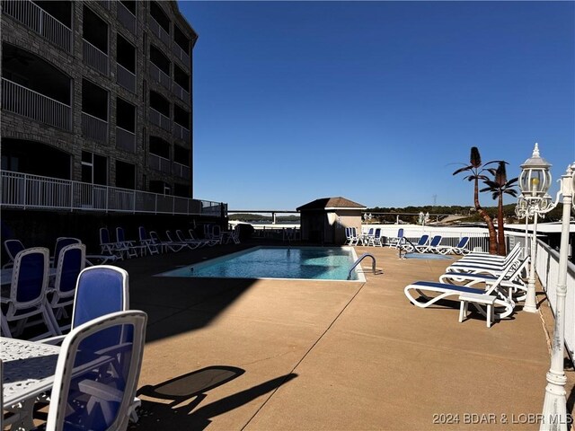 view of swimming pool with a patio area