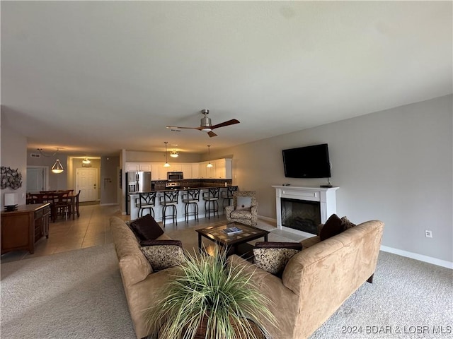 living room featuring light carpet and ceiling fan