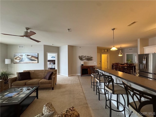 tiled living room with ceiling fan