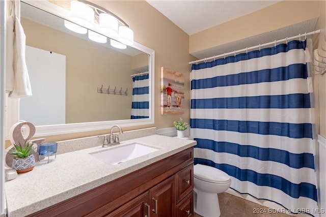 bathroom with vanity, curtained shower, a textured ceiling, tile patterned floors, and toilet