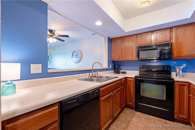 kitchen with black appliances, ceiling fan, sink, light tile patterned floors, and a textured ceiling