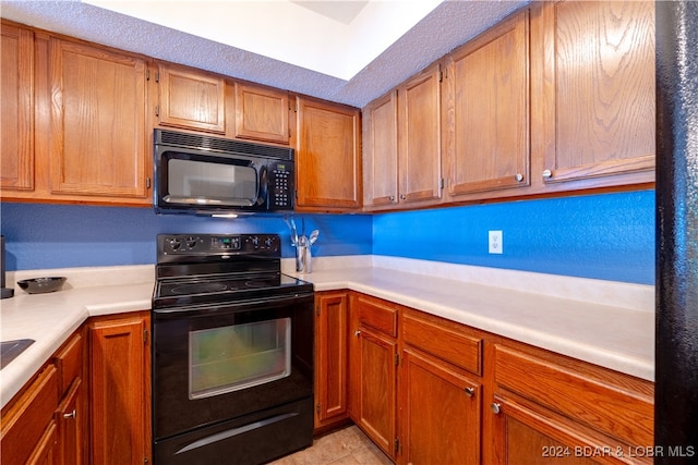 kitchen featuring black appliances and light tile patterned floors