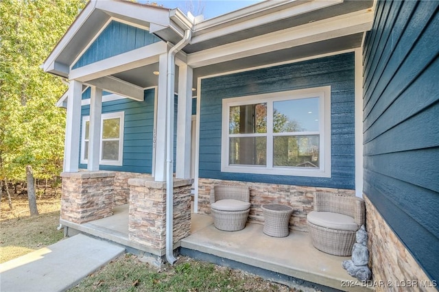 view of exterior entry with covered porch