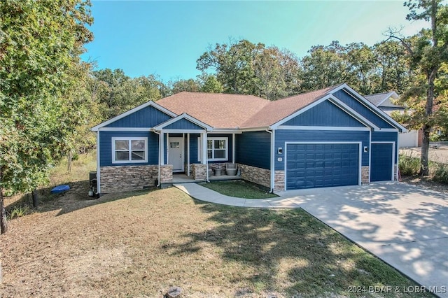 craftsman-style house featuring a front yard and a garage