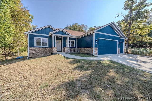 craftsman-style house with a garage and a front lawn