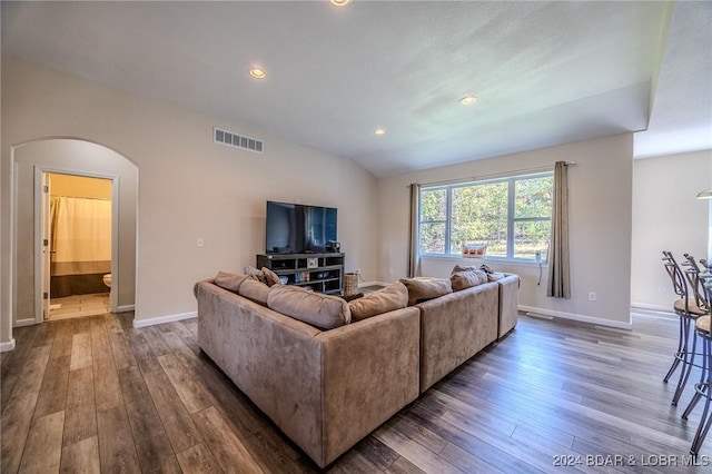 living room with dark hardwood / wood-style floors and vaulted ceiling