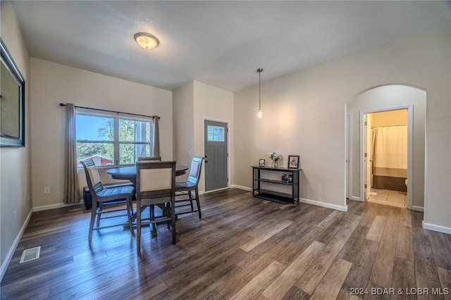 dining area featuring dark wood-type flooring