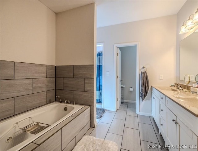 bathroom featuring tile patterned floors, a bathtub, and vanity