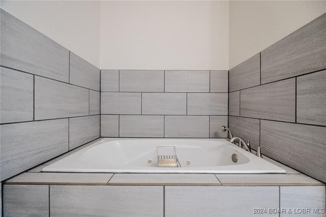 bathroom with tiled tub