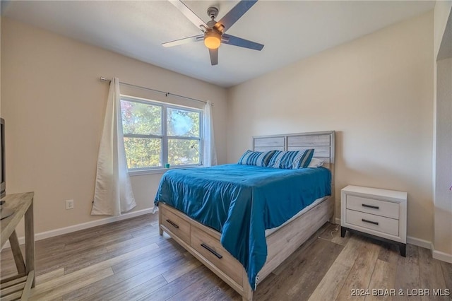 bedroom with hardwood / wood-style flooring and ceiling fan