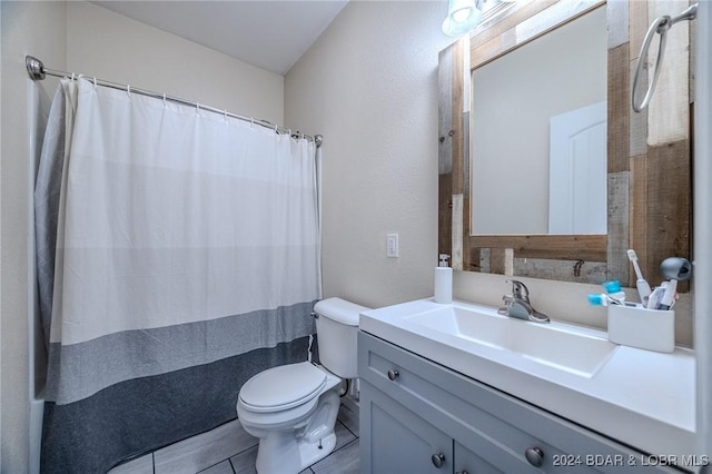 bathroom featuring a shower with curtain, tile patterned flooring, vanity, and toilet