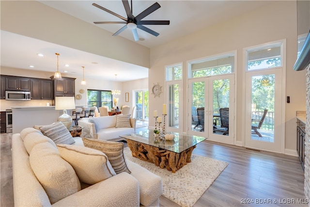 living room with light wood-type flooring and ceiling fan