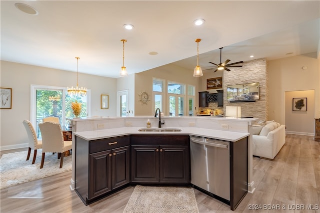 kitchen with sink, light hardwood / wood-style floors, pendant lighting, dark brown cabinets, and dishwasher