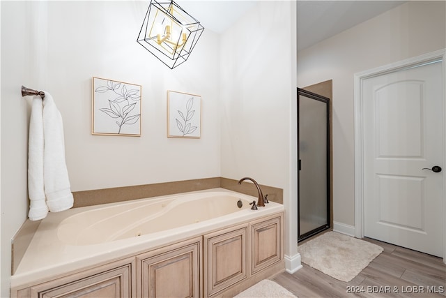 bathroom featuring independent shower and bath and hardwood / wood-style floors