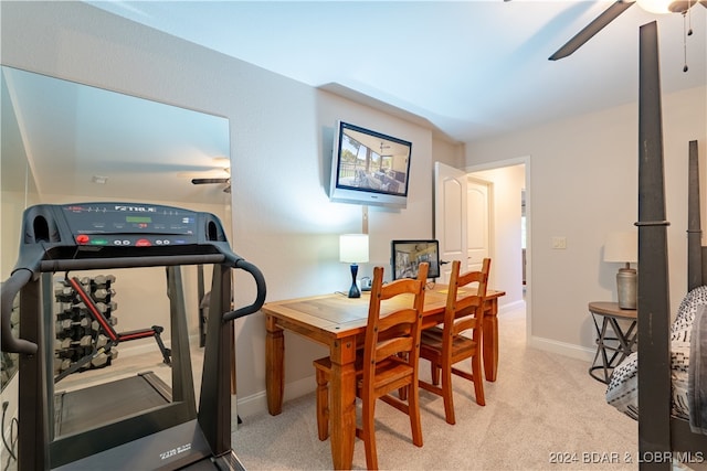 carpeted dining room featuring ceiling fan