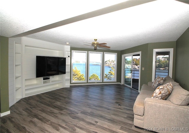 unfurnished living room with dark hardwood / wood-style flooring, a textured ceiling, and ceiling fan