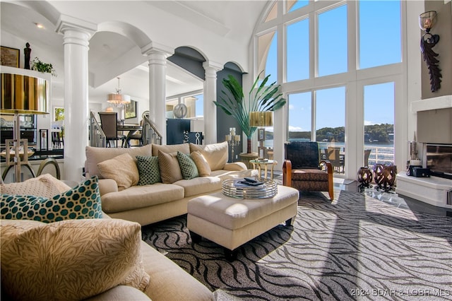 living room featuring high vaulted ceiling and a chandelier