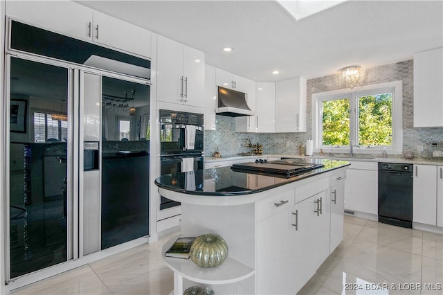 kitchen with tasteful backsplash, sink, double oven, a center island, and white cabinetry