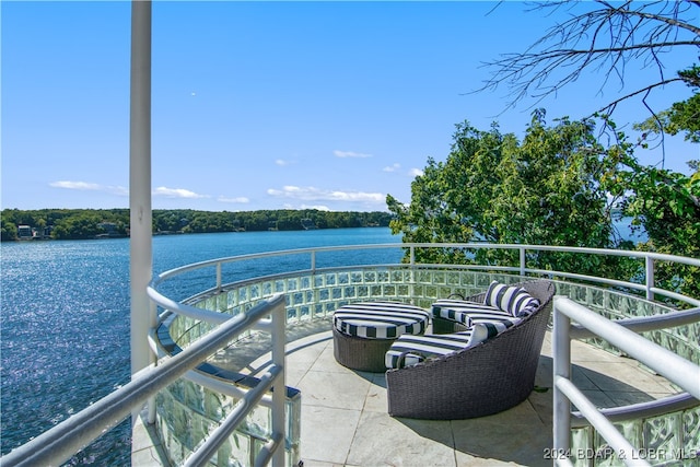 view of patio featuring a water view and a balcony